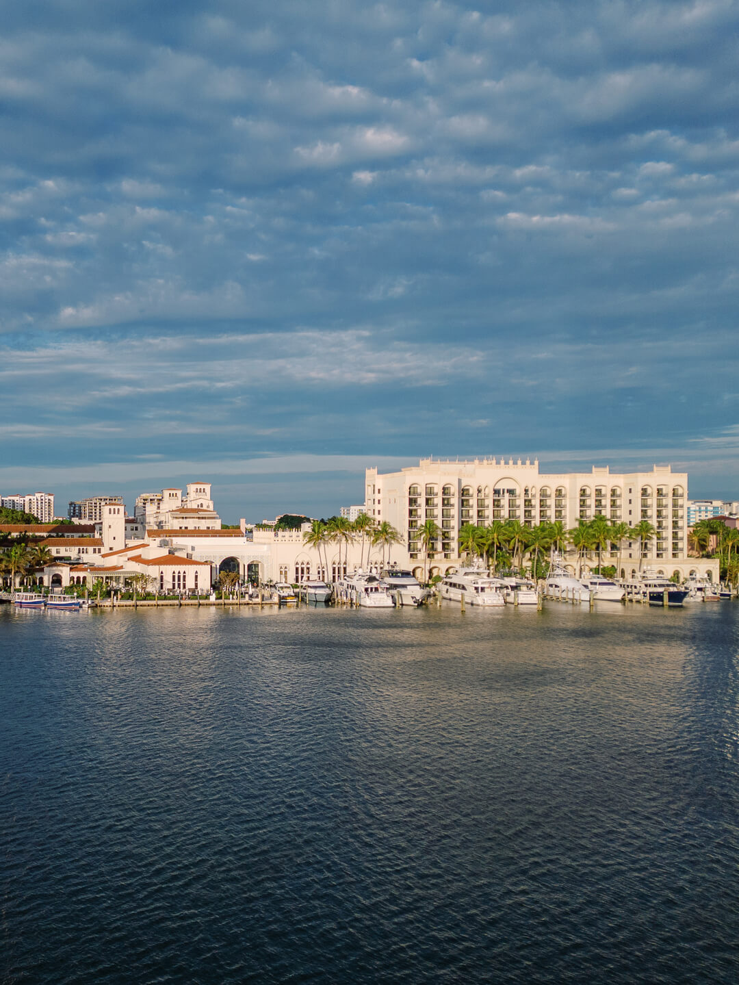 Exterior view of The Boca Raton resort, with Mediterranean Revival architecture and palm-lined approach.