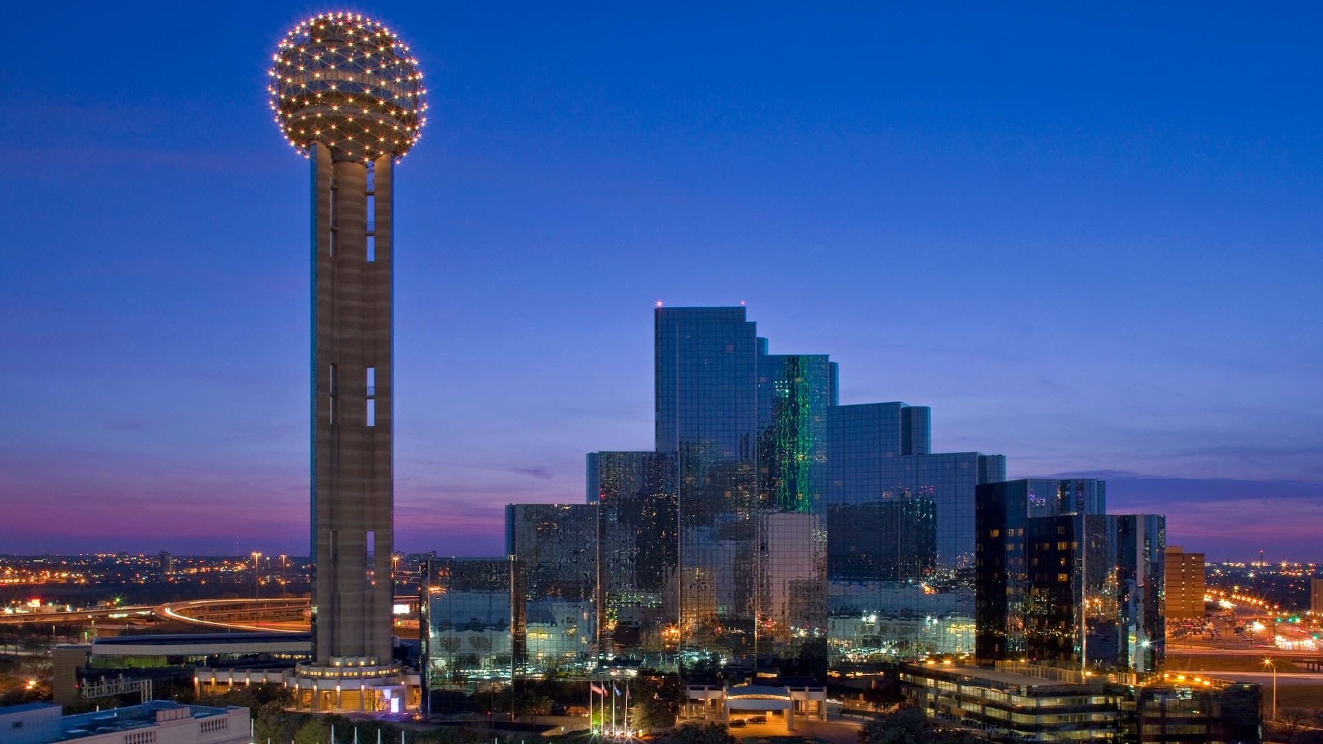 Hyatt Regency Dallas alongside Reunion Tower in the downtown Dallas skyline